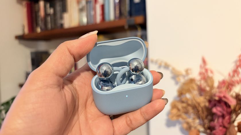 Huawei FreeClip 2 earbuds in blue finish, held in hand