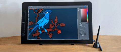 A Veikk Studio VK2200 Pro drawing tablet on a desk