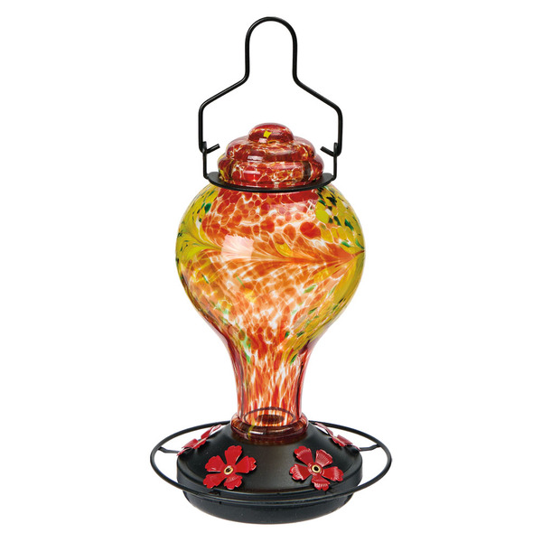 Red and yellow hand-painted glass hummingbird feeder with black base and red flower design