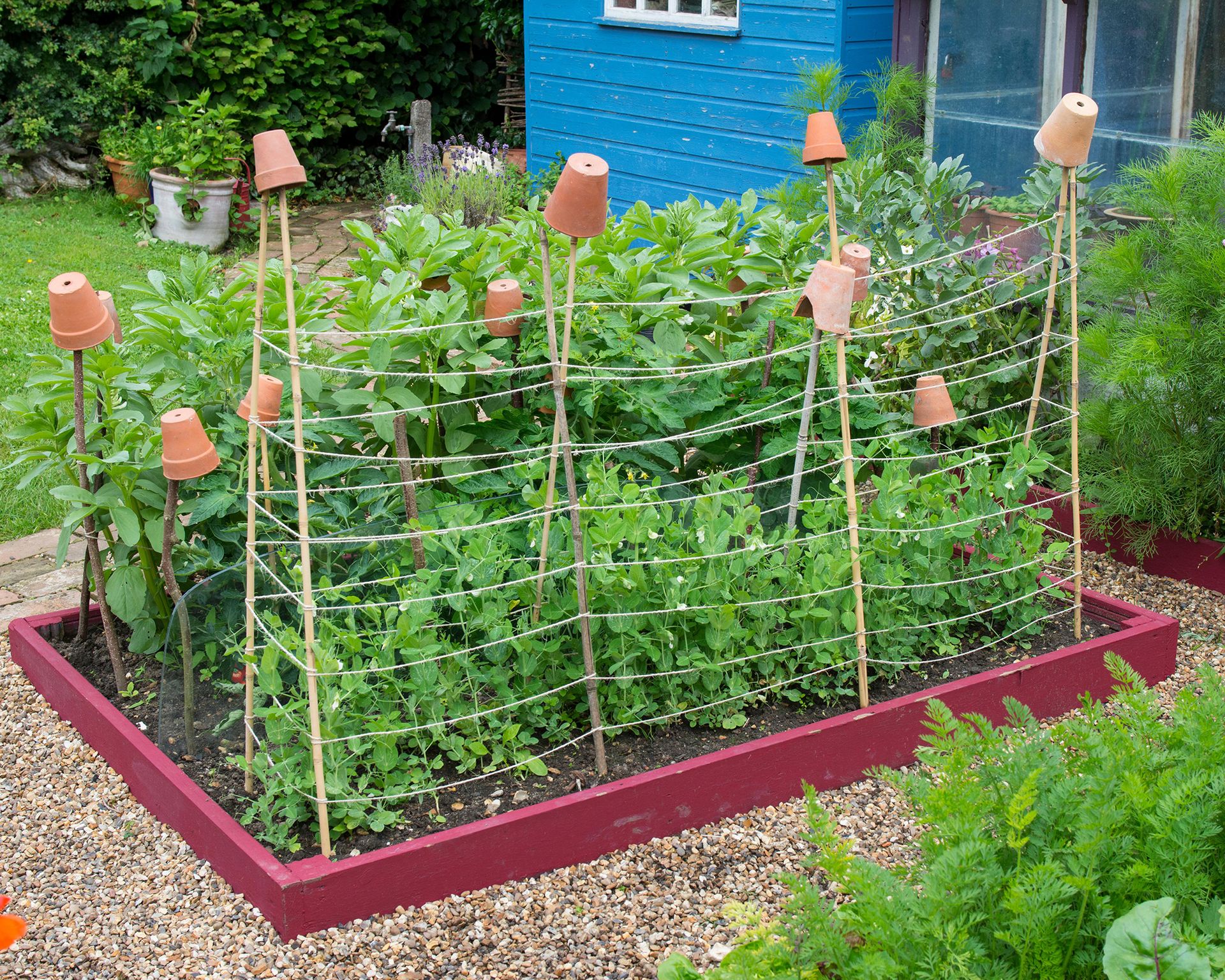 Red painted raised garden beds