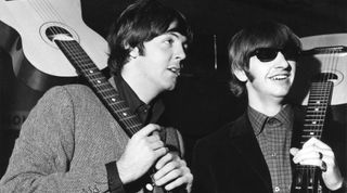 Paul McCartney and Ringo Starr hold Russian made guitars in 1965 