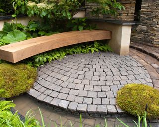 Garden bench and stone block paving patio