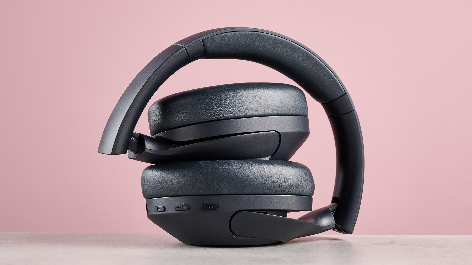 Tribit QuietPlus 81 folded up against pink background