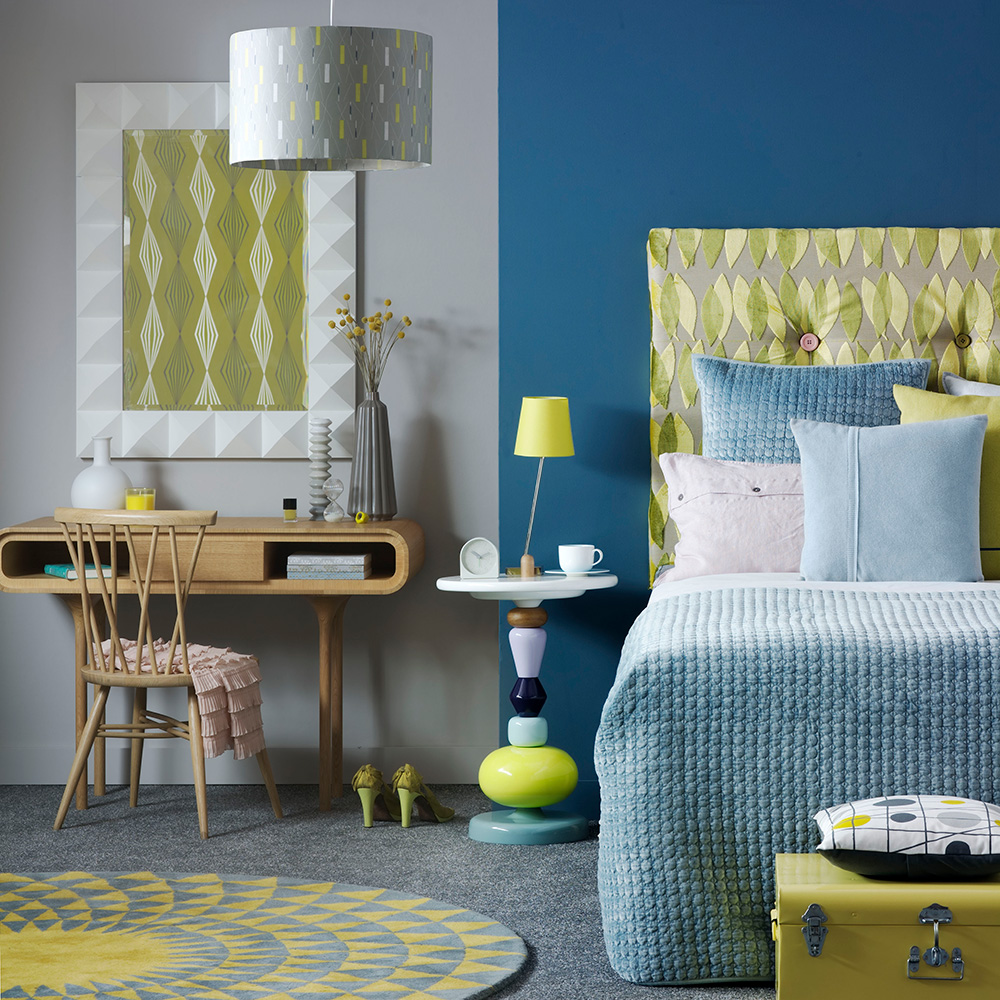 blue and grey wall bedroom and bed with cushions