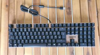 Cherry KC 200 MX gaming keyboard on a wooden table.