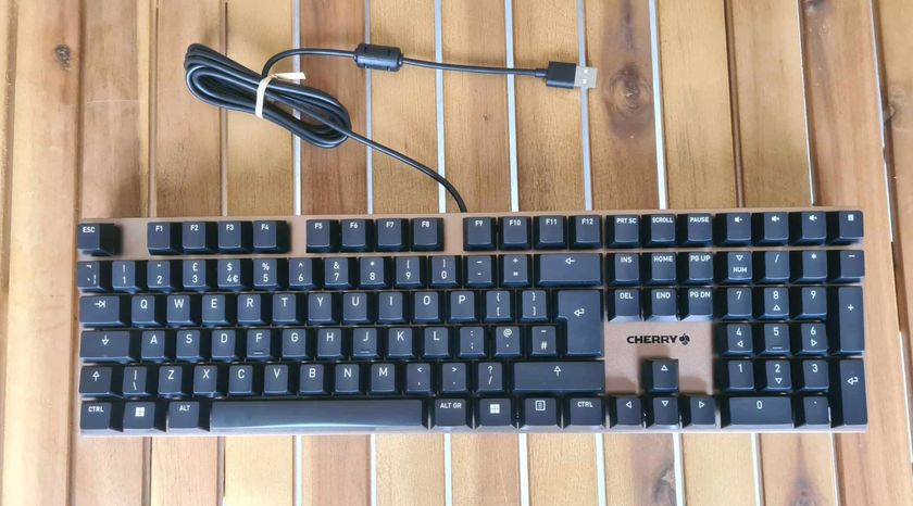 Cherry KC 200 MX gaming keyboard on a wooden table.