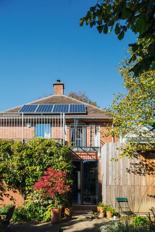 extension to brick house with solar thermal panels on roof