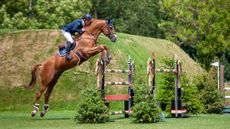 Shane Breen jumping Golden Hawk in front of the Hickstead Derby Bank