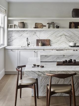 white and grey modern kitchen with wood chairs