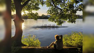 A boy sitting by the Thames 