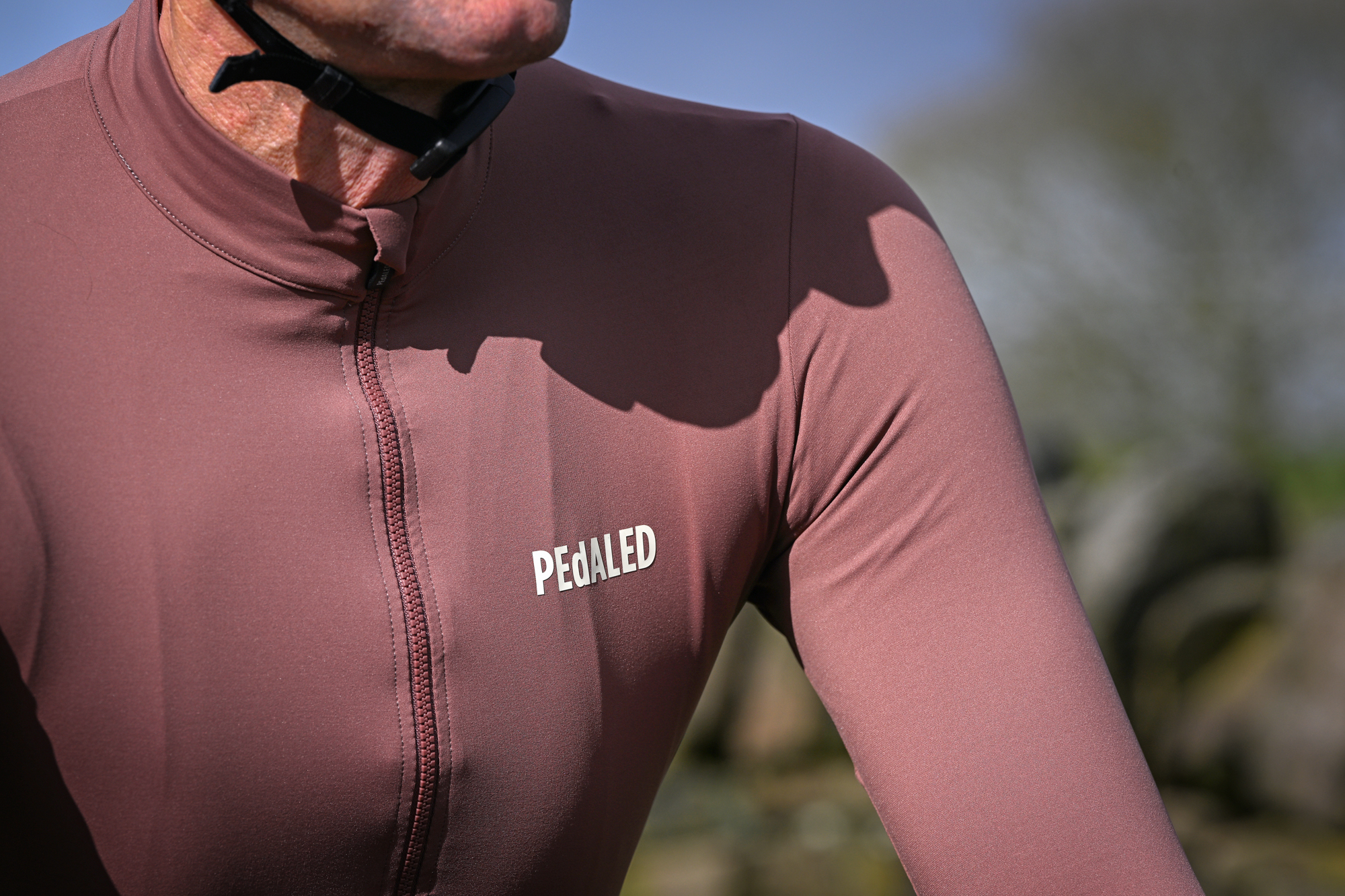 close up of the PEdALED branding on a purple jersey