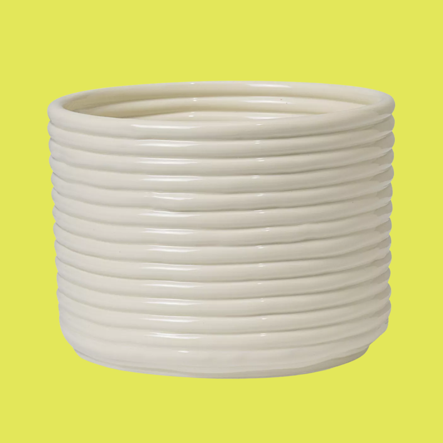 A corduroy plant pot with an off-white glaze