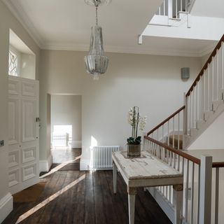 corridor with white walls and wooden flooring