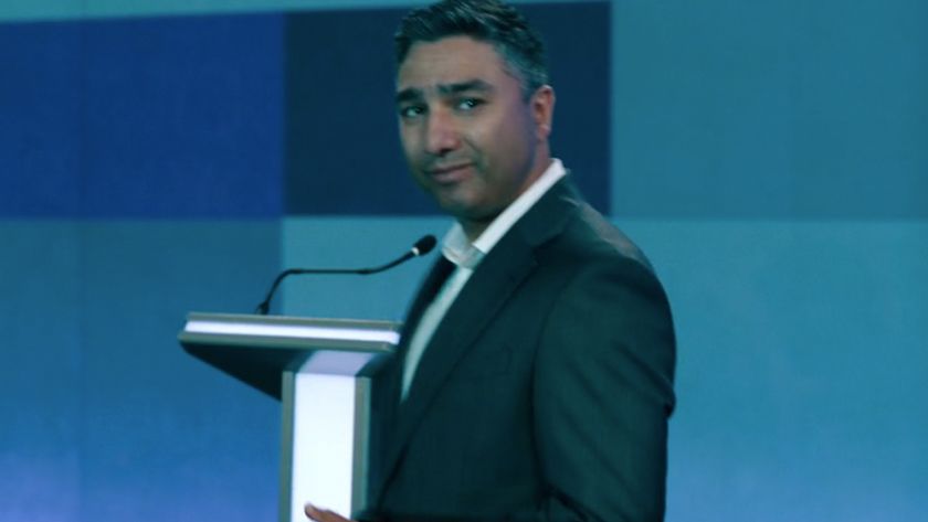 Nick Mohammed looking over his shoulder with a little smirk in Slow Horses