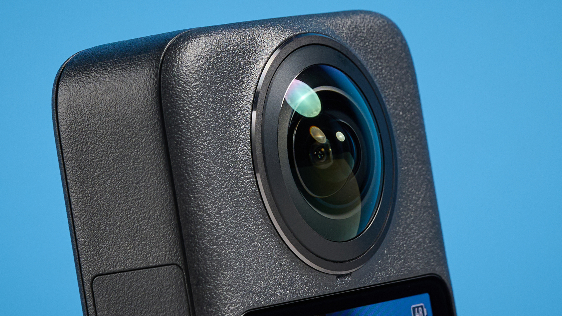 The DJI Osmo 360 lens against a blue background