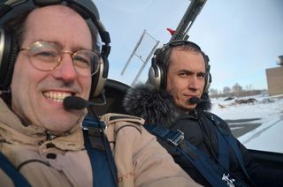Peter Jenniskens (left) and pilot Eduard Kalinin during an aerial inspection of the fall area. Image released Nov. 6, 2013.