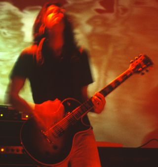 Adam Jones performs onstage with Tool at the Oakland Coliseum Arena in Oakland, California on December 31, 1995