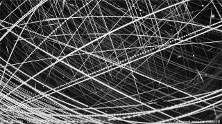 black and white photo showing the dark sky crisscrossed by dozens of bright lines