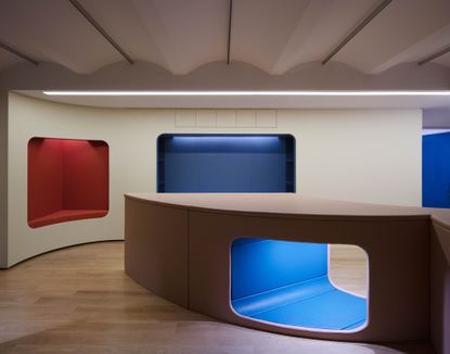 Colourful playroom with large scale furniture in red, blue and white.