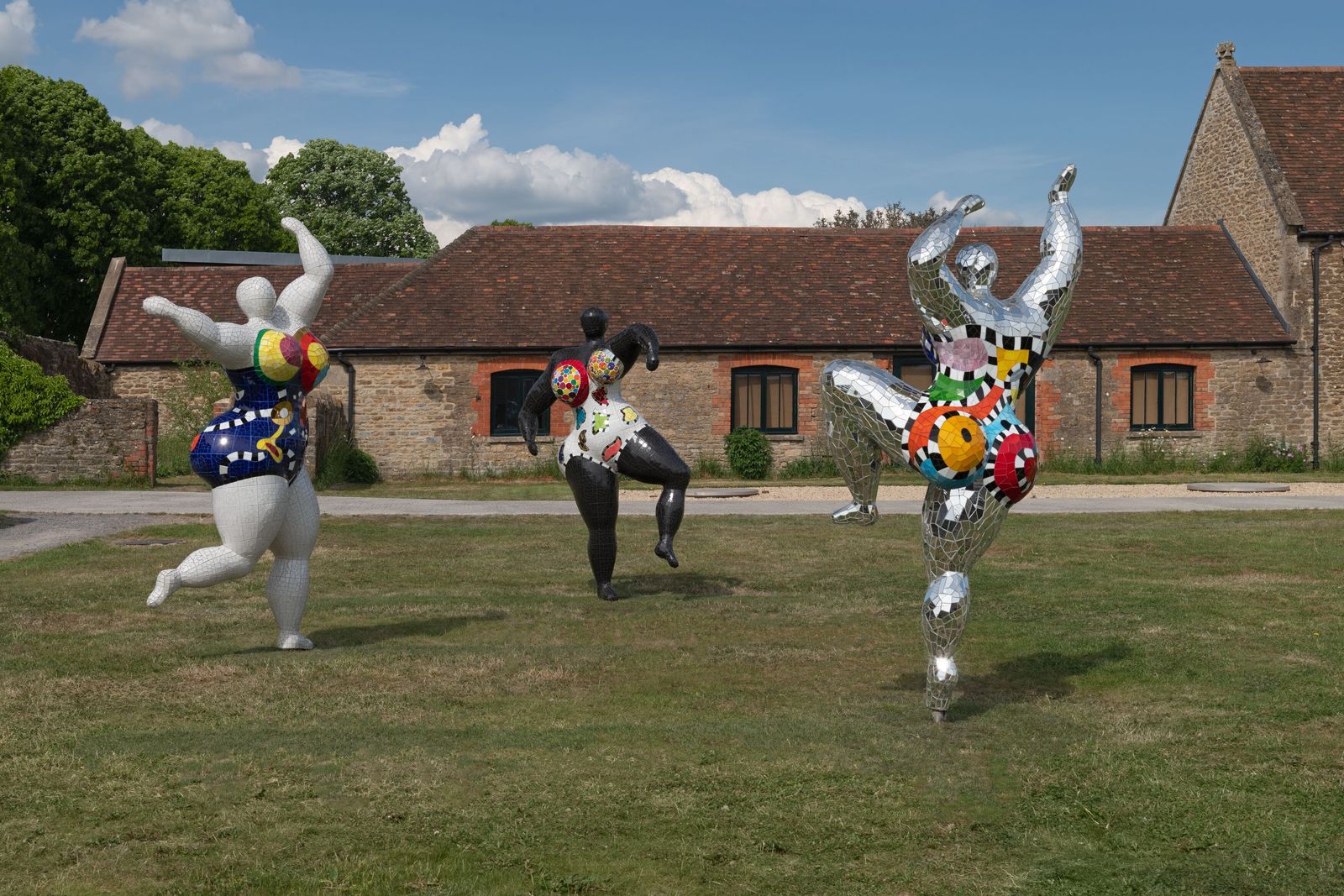 sculptures of dancing figures outside