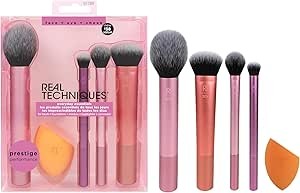 Pink packaging with four makeup brushes in it and an orange sponge with all the brushes next to it