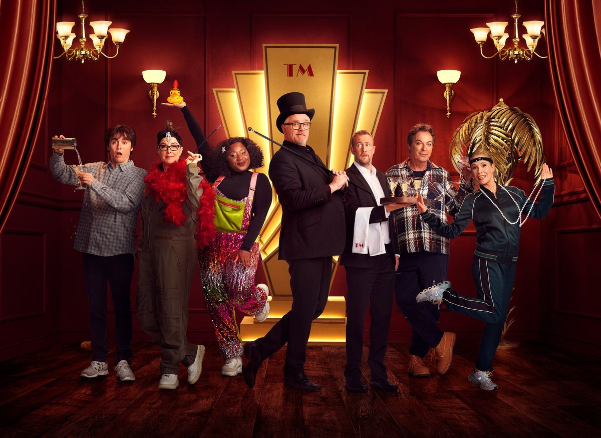 Taskmaster season 16 line up posing with host Greg Davies and assistant Alex Horne