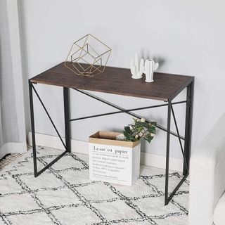 folding desk with rug and white wall