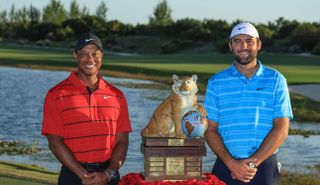 Tiger Woods and Scottie Scheffler stand next to the Hero World Challenge trophy