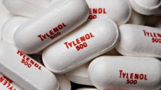 a close-up of white pills printed with the words "Tylenol 500" 