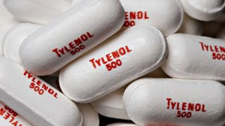 a close-up of white pills printed with the words "Tylenol 500"