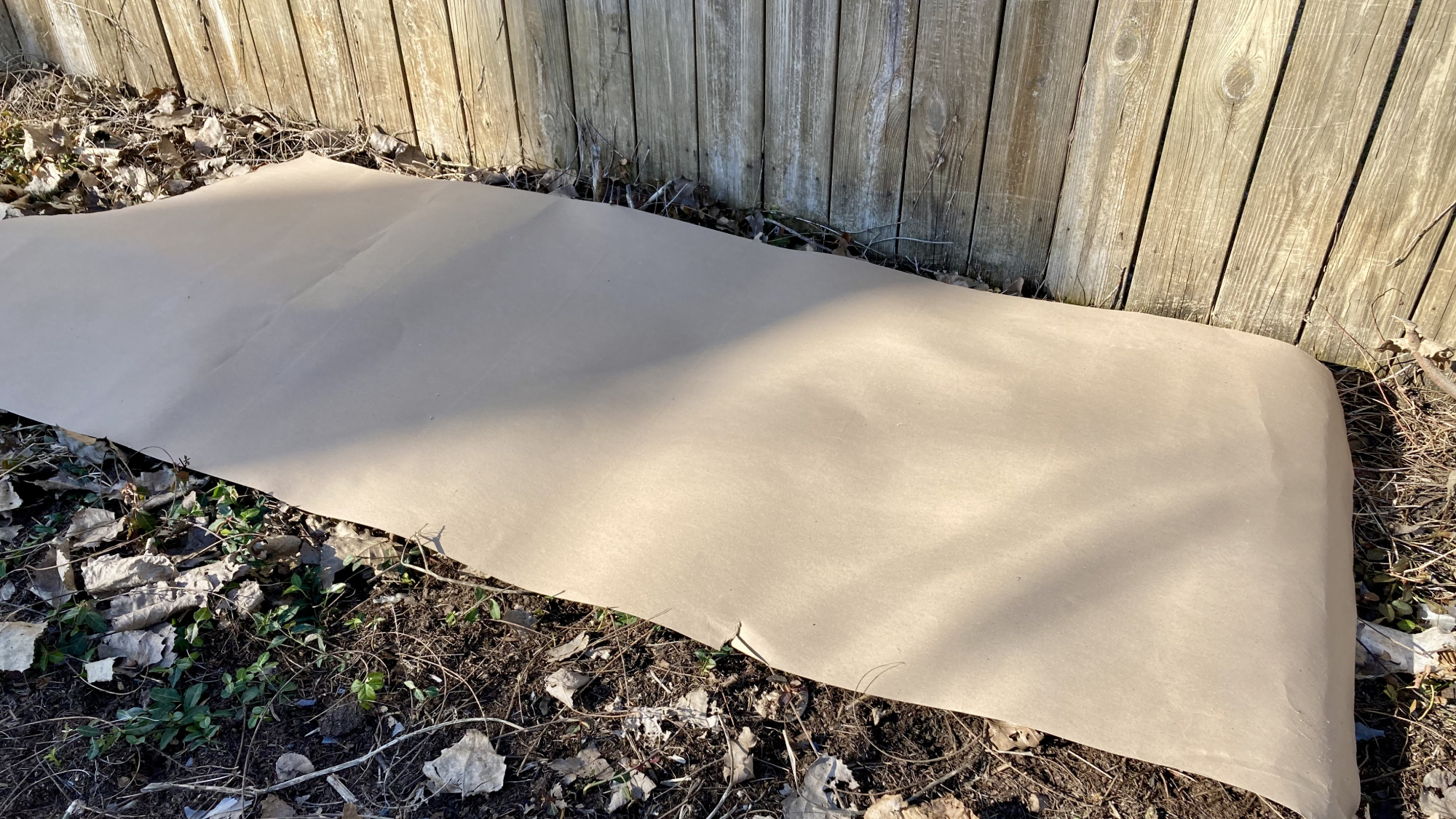 ram board covering weeds in garden