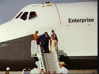 Astronauts Joe H. Engle (looking down), commander, and Richard H. Truly (face partially obscured by Engle), pilot, are greeted by Rockwell technicians following egress from the Space Shuttle Orbiter 101