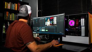 Man editing video using the best free video editing software in a home studio
