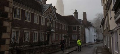 Salisbury Cathedral emerges from a morning fog in town centre