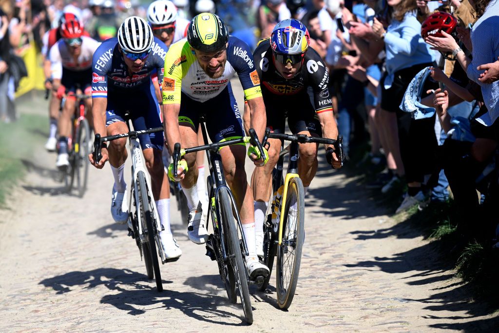 ROUBAIX FRANCE APRIL 17 LR Mathieu Van Der Poel of Netherlands and Team AlpecinFenix Adrien Petit of France and Team Intermarch Wanty Gobert Matriaux and Wout Van Aert of Belgium and Team Jumbo Visma compete in the chase group passing through a cobblestones sector during the 119th ParisRoubaix 2022 Mens Elite a 2572km one day race from Compigne to Roubaix ParisRoubaix WorldTour on April 17 2022 in Roubaix France Photo by Bernard Papon PoolGetty Images