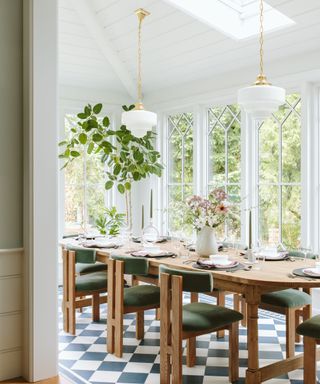 light and airy dining room with white wood ceiling and large windows