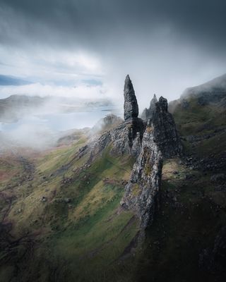 A rocky peak on a hill under grey cloud