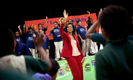 Michelle Obama exercises with students last April during a Let&amp;#039;s Move event.