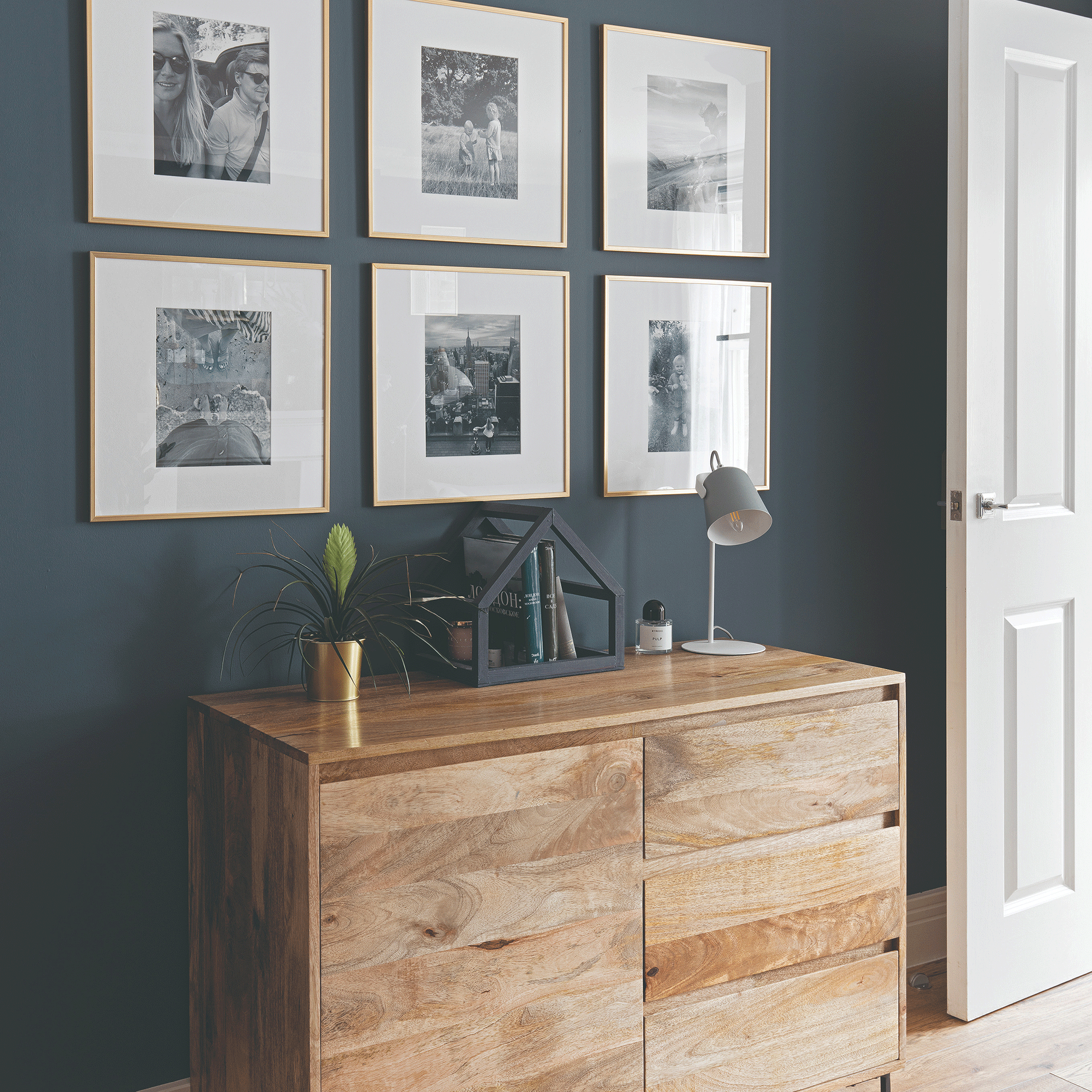 Wooden sideboard with gallery wall