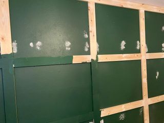 Creating a DIY wooden accent wall painted in green