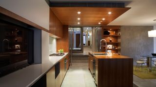 Large kitchen with multiple lighting sources creating ambient light