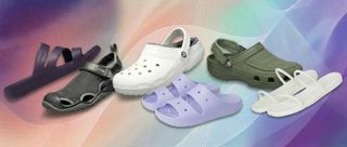 Crocs on display with rainbow gradient background