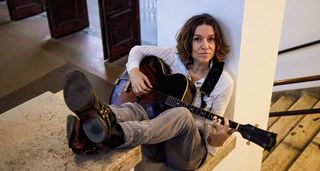 Ani DiFranco poses with a vintage arch-top