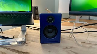 AudioEngine A2+ in blue on a desktop, straight on view