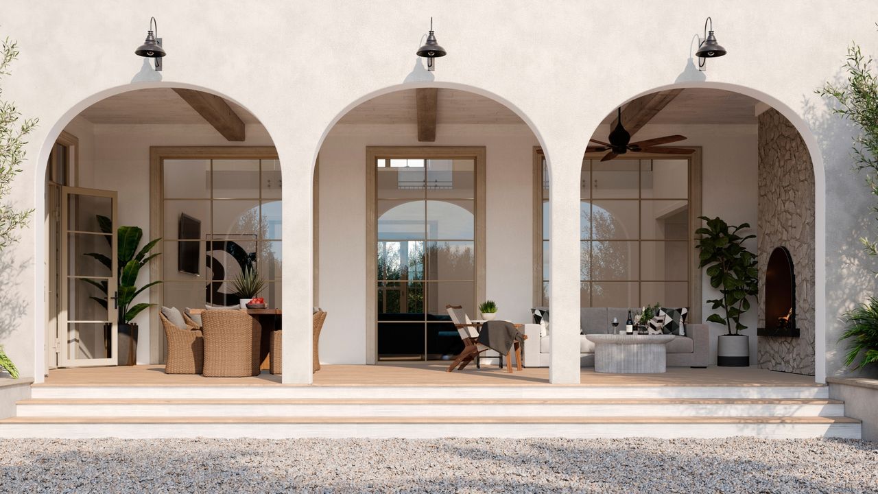 Bright home exterior with three large archways, revealing windows and outdoor porch with rattan furniture and tall plants.