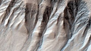 A spectacular example of gullies on Mars, at roughly 71 degrees latitude in the southern hemisphere. 