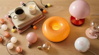Collection of warm-coloured IKEA lights on wooden table