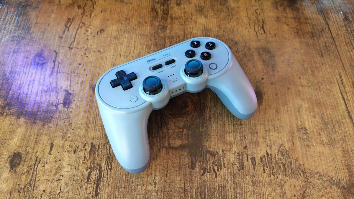 An 8BitDo Pro 3 review image showing the controller on a wooden desktop