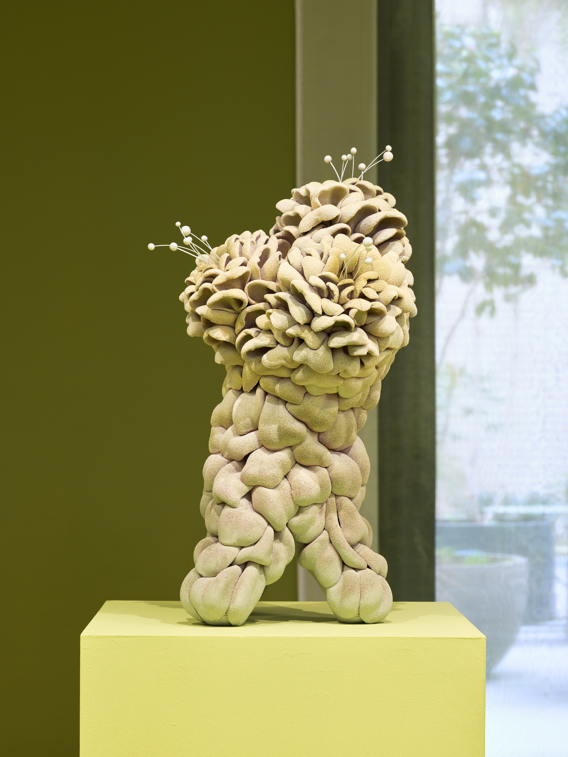 Futuristic ceramics in green gallery space