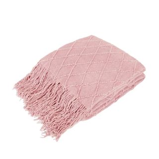 A folded dusky pink blanket with tassels, tilted to the left